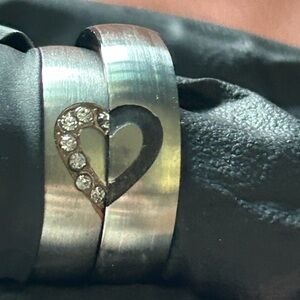 2 rings a brushed stainless steel matching couples set featuring a heart design